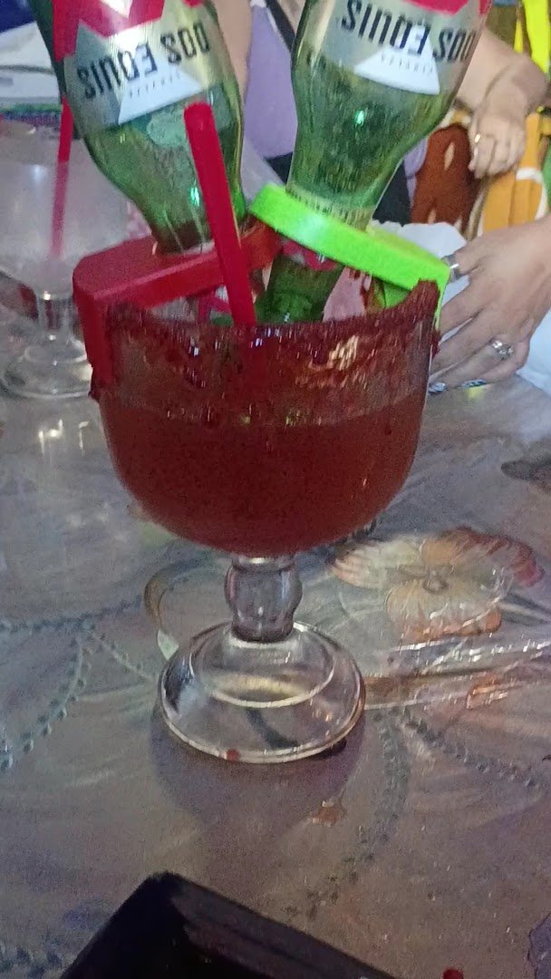 Casual restaurant tables with drinks and shared plates.