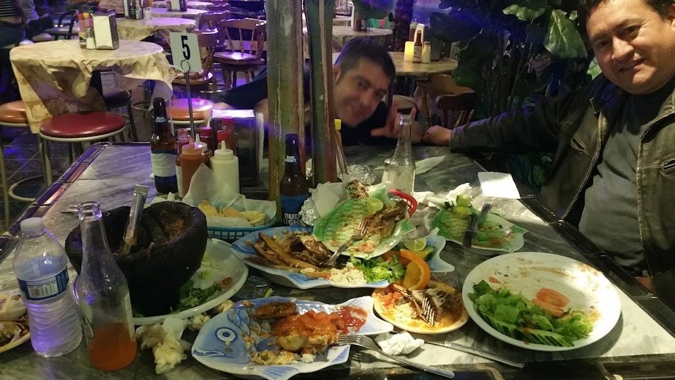 Printed menu with seafood and kids options.